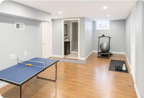 a living room with a ping pong table in it at Spacious Three Bedroom Parma Home Sleeps six Near Cleveland in Parma