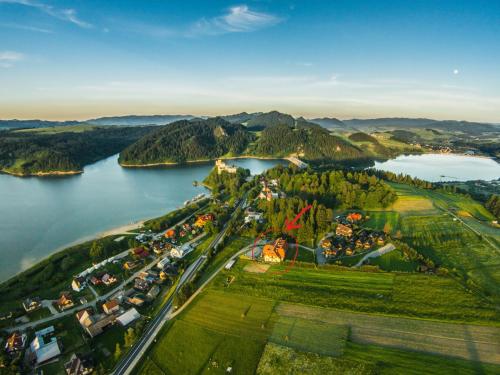 an aerial view of a town next to a lake at Hotel LOKIS in Niedzica Zamek