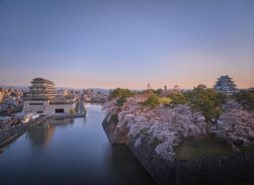 a view of a river with a city and buildings at Espacio Nagoya Castle, The Leading Hotels of the World "LHW" in Nagoya