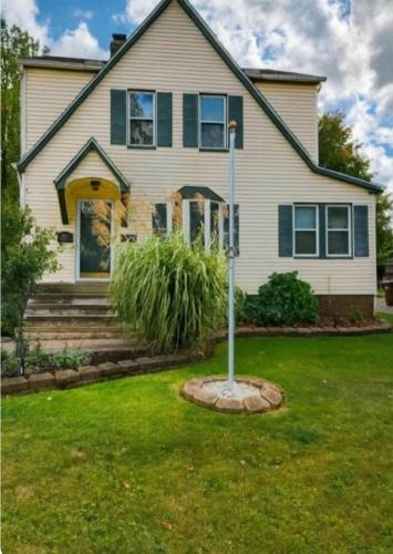 a house with a street sign in the yard at Spacious Three Bedroom Parma Home Sleeps six Near Cleveland in Parma