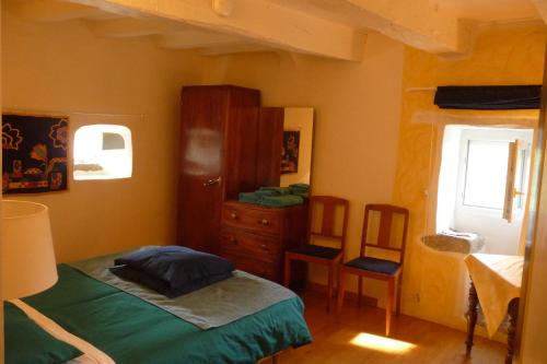 a bedroom with a bed and a dresser and a mirror at La Hulotte in Limogne-en-Quercy