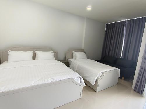 Un ou plusieurs lits dans un hébergement de l'établissement Airport Stay Phuket Zz