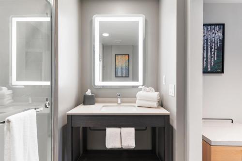 a bathroom with a sink and a mirror at Hyatt House Thunder Bay in Thunder Bay