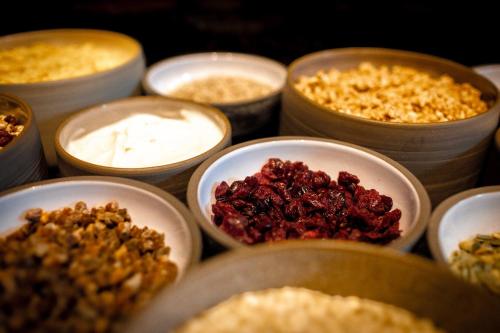 a group of bowls filled with different types of food at The Cloud One Frankfurt - Metropolitan in Frankfurt/Main