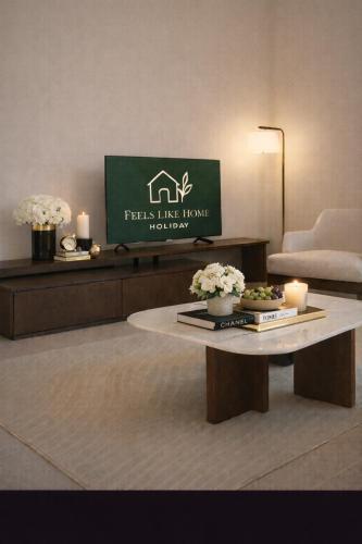 a living room with a coffee table and a tv at Elegant 1BR Yas Island with Theme Park Views & Exclusive Yas Park Offers in Abu Dhabi
