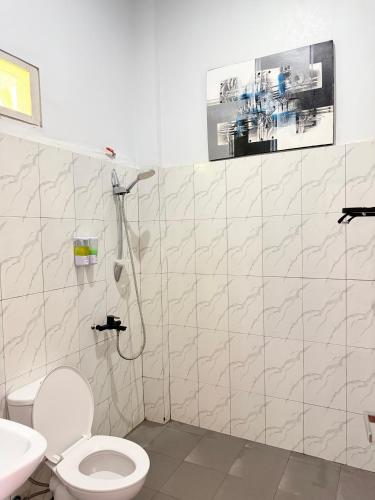 a bathroom with a toilet and a sink at Manta Manta Guesthouse in Labuan Bajo