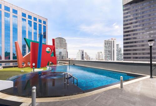 a swimming pool on the roof of a building at S31 Sukhumvit Hotel in Bangkok