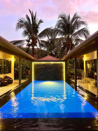 a swimming pool in the backyard of a house at Khaolak Alisa House in Khao Lak