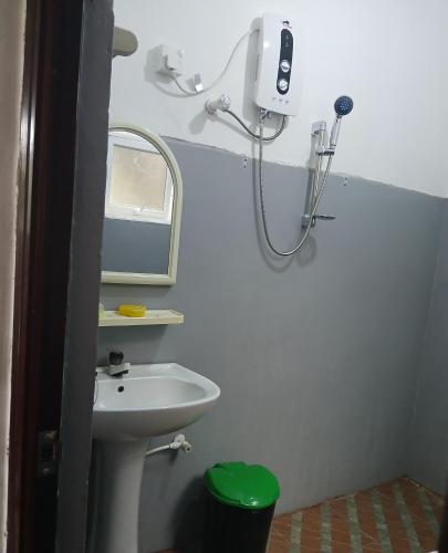 a small bathroom with a sink and a shower at Kumari villa in Weligama