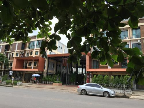 a silver car parked in front of a building at Chivapuri Trat in Trat