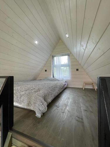 a bed in the middle of a room at Серце Карпат in Skole