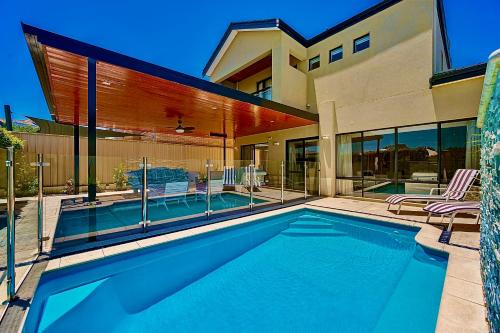a swimming pool in front of a house at Luxury Villa W Pool & Spa 5 BEDROOMS in Coogee