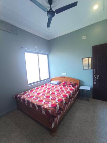 een slaapkamer met een groot bed in een kamer met een raam bij Om guest house in Jasidih