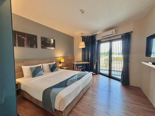 En eller flere senge i et værelse på Blue Rabbit Hotel