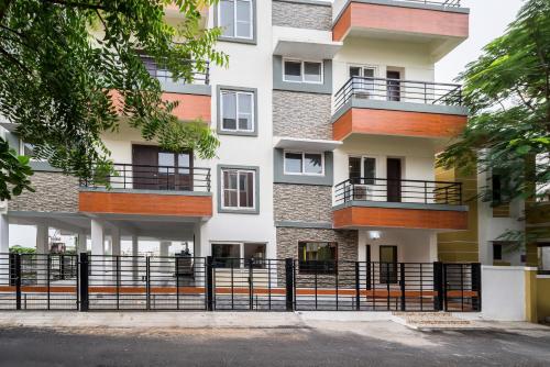 an apartment building with a fence in front of it at Treebo Trend Adin Residence Chennai Trade Centre in Chennai