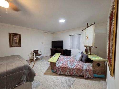 a bedroom with a bed and a television in it at Coastal Retreat by TPA & Stadium in Tampa