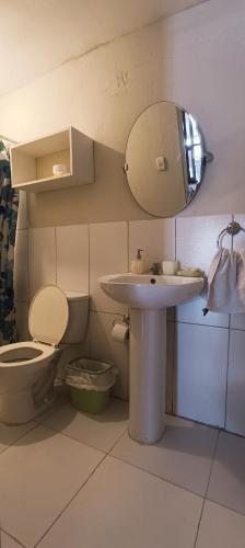 a bathroom with a toilet and a sink and a mirror at Villa Naylamp loft8 playa pocitas in Máncora