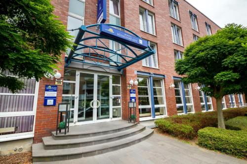 a building with a staircase in front of a building at HK Hotel Düsseldorf City in Düsseldorf