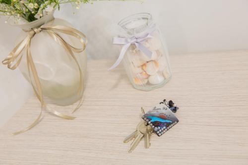 a small figurine of a beetle next to a jar of eggs at SONRE' B&B in Ruffano