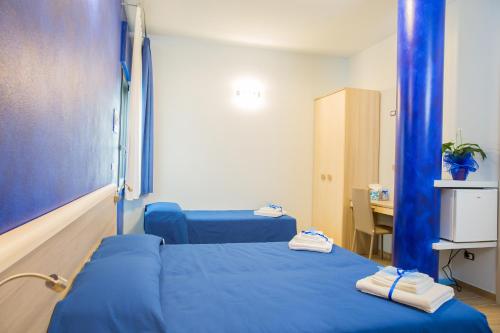a hospital room with two beds with blue sheets at SONRE' B&B in Ruffano