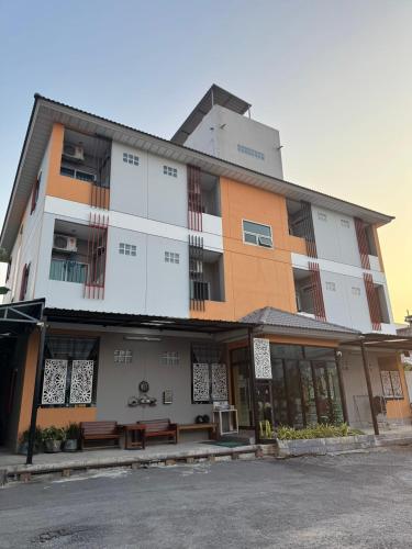 a building with benches in front of it at Firstbuild Apartment (เฟิร์สบิวท์อพาร์ทเม้น) in Bangkok