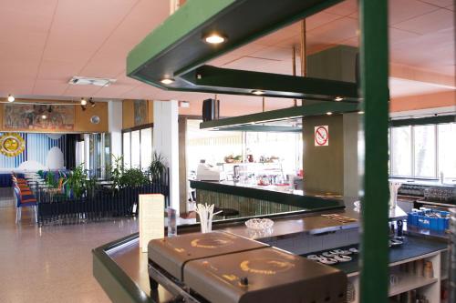 a restaurant with a counter with luggage on it at Xon's Platja HA in Empuriabrava