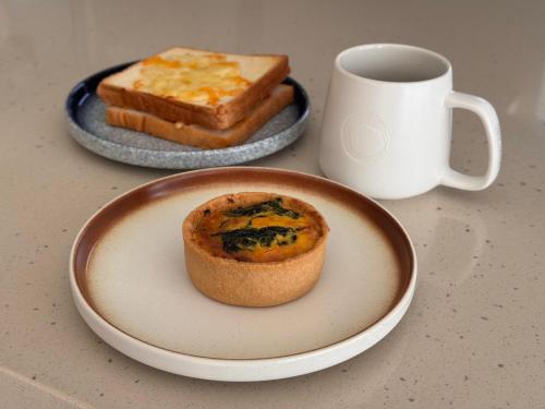 a plate with a piece of bread and a cup of coffee at The O Villa Jiaoxi in Jiaoxi