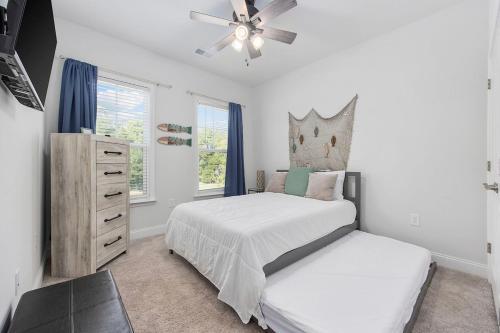 a bedroom with a bed and a ceiling fan at Birdie Bungalow- Games Beach Gear Sleeps 10 in Myrtle Beach