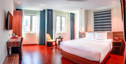 Postel nebo postele na pokoji v ubytování Bon Ami Hotel - Thiên Xuân Hotel