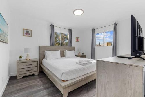 a bedroom with a bed and a flat screen tv at Azul Condos - Ocean steps away - Full Kitchen in Myrtle Beach