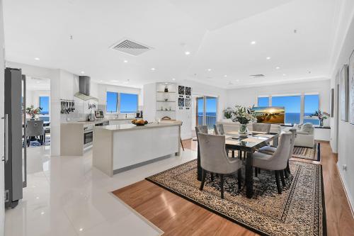 a kitchen and living room with a table and chairs at Belle Maison Apartments - Official in Gold Coast