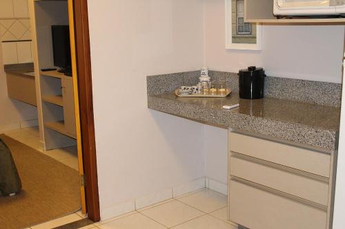 a kitchen with a sink and a counter top at Pousada Canto do Sabiá - Pirenópolis in Pirenópolis