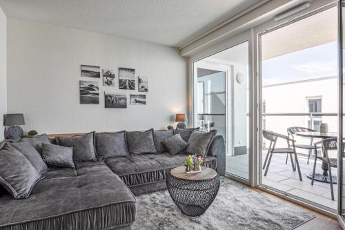a living room with a couch and a table at Seeluft Olpenitz in Olpenitz