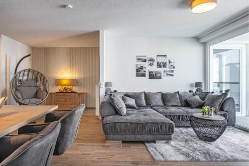 a living room with a couch and a table at Seeluft Olpenitz in Olpenitz