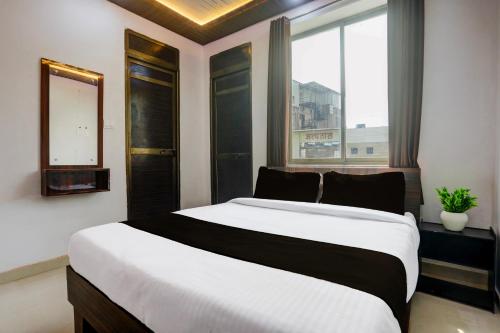 DarbhangaHOTEL O MJ INN的一间卧室，配有一张大床和一扇窗户。