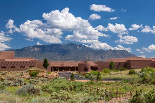 a building in the desert with mountains in the background at Hyatt Regency Tamaya South Santa Fe in Santa Ana Pueblo