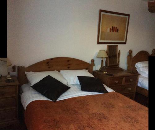 a bedroom with a bed with two pillows on it at The White Horse Inn, Clun in Clun