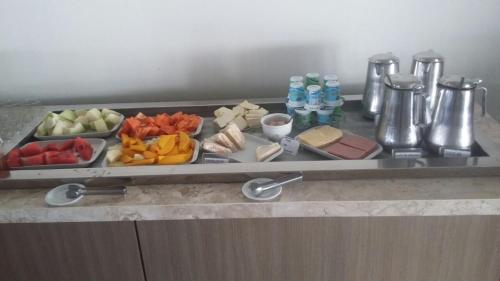a tray filled with different types of food on a table at Oasis Hotel in Cajazeiras