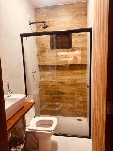 a bathroom with a shower and a toilet and a sink at Casa Vista Mar - Praia do Frances in Marechal Deodoro