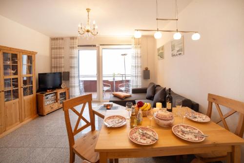 a living room with a wooden table with plates on it at Schnuckeliges Appartement in Sankt Andreasberg