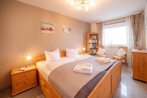 a bedroom with a large bed with two towels on it at Schnuckeliges Appartement in Sankt Andreasberg