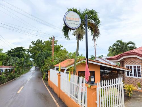 a sign for a restaurant on the side of a street at Namasté Olango Guest House in Olango Island