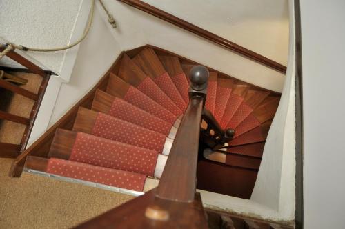 a spiral staircase with red and white at Le Preconil in Sainte-Maxime
