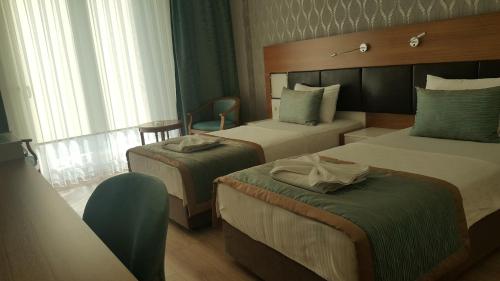 Postel nebo postele na pokoji v ubytování Hotel Kabacam Aydin