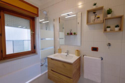 a bathroom with a sink and a mirror at Tree home in Salerno Airport - Aeroporto di Salerno