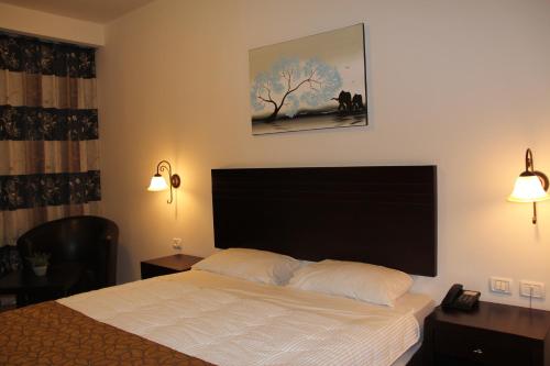 Ένα ή περισσότερα κρεβάτια σε δωμάτιο στο Restal Hotel