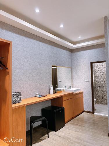 a bathroom with a sink and a counter with a mirror at 夏日微醺二館 in Hengchun South Gate
