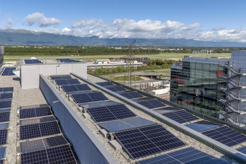 a group of solar panels on the roof of a building at Hilton Geneva Hotel and Conference Centre in Geneva