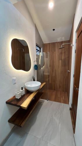 a bathroom with a sink and a shower at Casa Margarita in Pátzcuaro