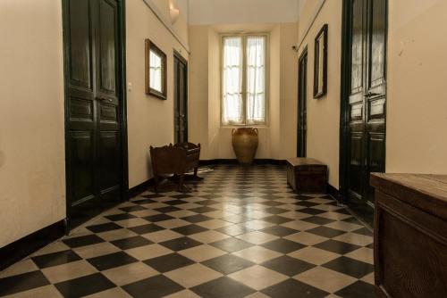 a hallway with black doors and a checkered floor at Hotel Florenz in Finale Ligure